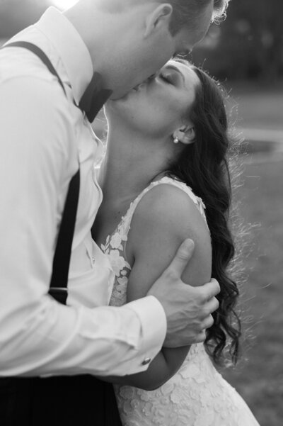 A couple leans in for a kiss.