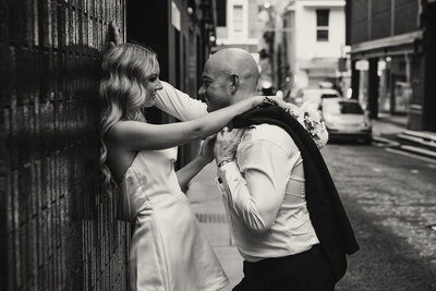 Candid black-and-white portrait of a couple sharing an intimate moment, captured on the Sunshine Coast.