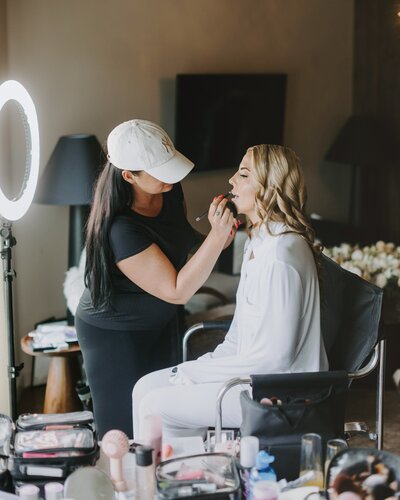 Jessica providing on-location wedding makeup to bride during getting-ready session.