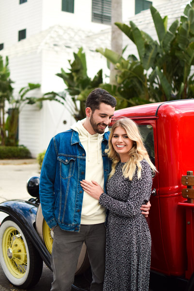 Couple in front of vintage red truck Celebration Florida