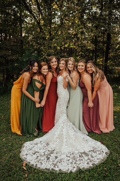 Bridal party with bride wearing colorful dresses