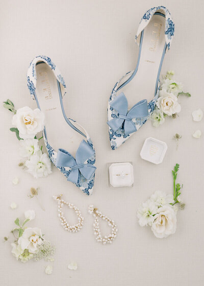 Bride's shoes styled with flowers and rings by event planning minneapolis.