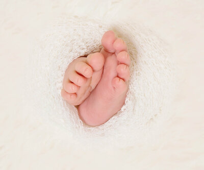 baby feet in white wrap photographed by Los Angeles newborn photographer