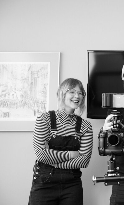 Film producer Cassi Angier smiles on set, representing the executive producer services she offers. 