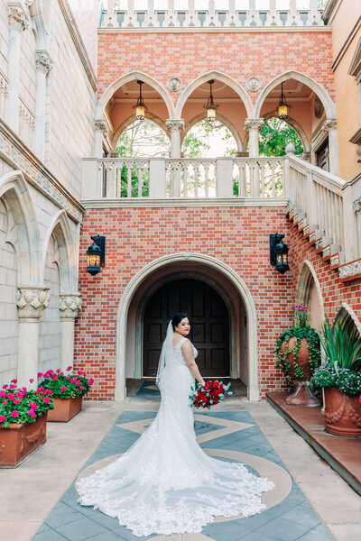 Portrait of Bride in Italy pavilion in Epcot with red bouquet