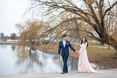 Couple walking through park holding hands