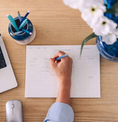woman writing in calendar