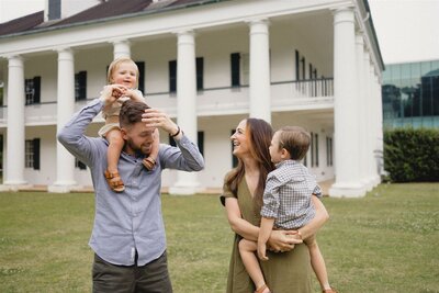 family laughing in front of hilliard museum