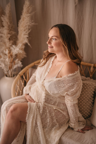 Photo of a pregnant woman wearing a lace dress