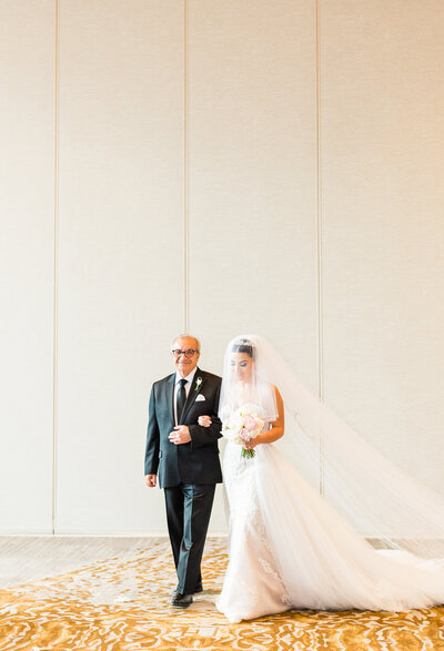 bride + father walk down the aisle