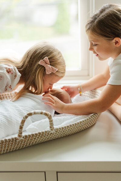 Minneapolis newborn photography session with sweet siblings and their newborn baby