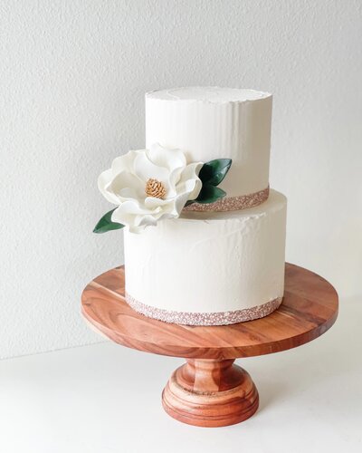 Close up of a Modern magnolia Sugar flowers On a two tier cake