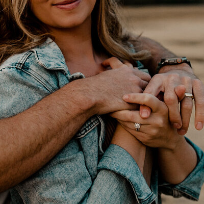 Couples hands intertwined in an engagement photo