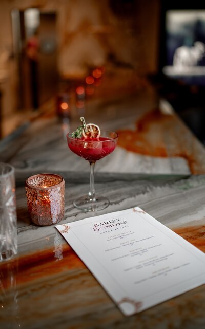 Restaurant design details featuring custom menu and signature cocktail - hospitality interior design services in action.