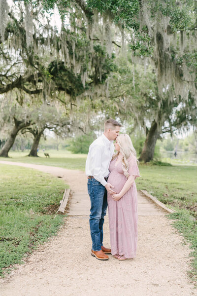 Husband embraces his pregnant wife during maternity photography session