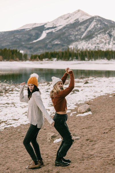 Candid photo of Kelsey & Stefanie with mountain backdrop