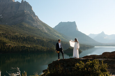 couple standing on bozeman mountain top embracing in a kiss