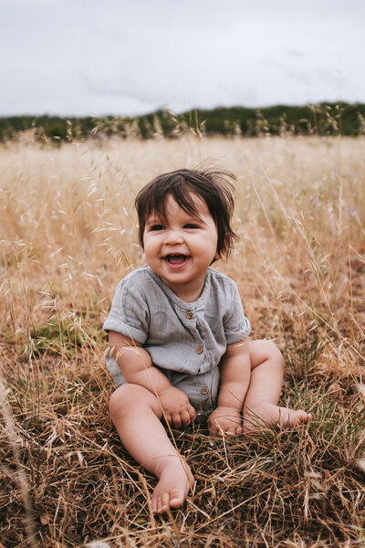 Cute baby laughing in paddock in Adelaide