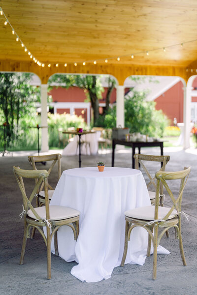white linen table ready for cocktail hour under event pavilion at Windridge