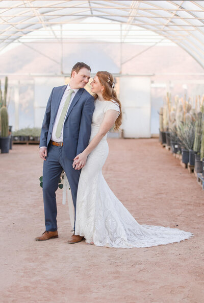 Bride and groom happily holding hands in a beautiful greenhouse  in Las Vegas, Nevada