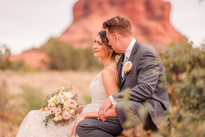 bride and groom on red rock in Sedona, AZ
