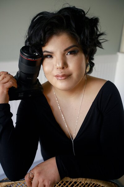 dani looking at camera, dani has black hair and heavy glam makeup