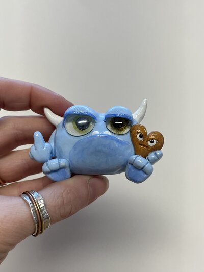 Natalie holding artistic stuffed creature
