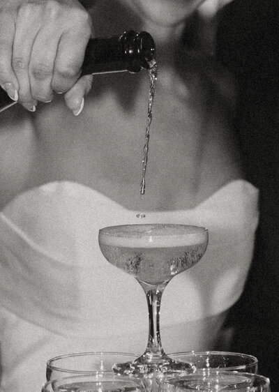 bride pouring champagne