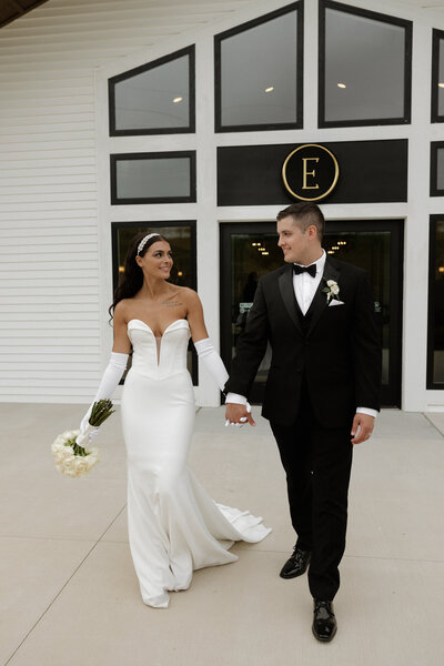 Photo of married couple standing outside The Eloise's front doors