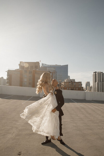 bride and groom dance on san diego rooftop after wedding ceremony
