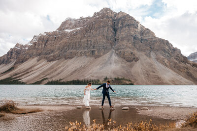 Couple exploring Bow Lake in Banff