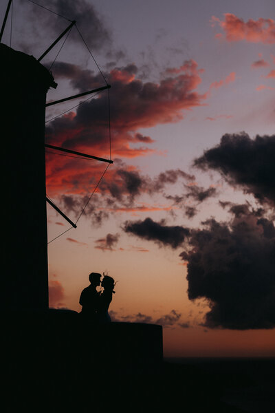 couple at sunset in santorini greece
