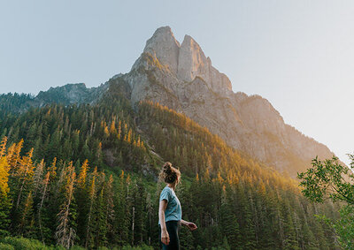 Girl hiking near tall mountain in washington