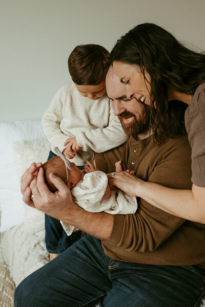 Family session in a studio with their newborn in Waterloo, Ontario.