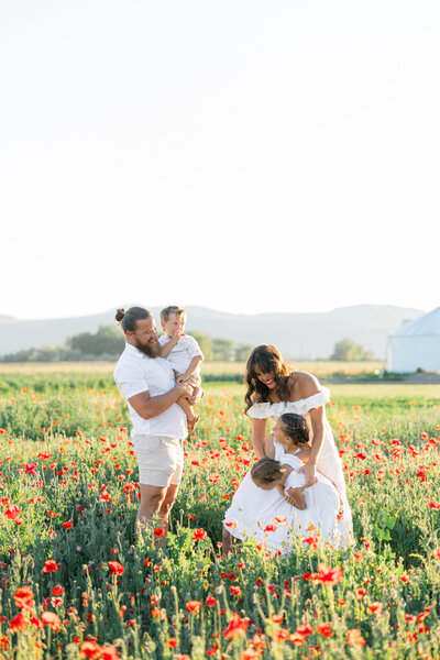 family playing in poppy flowers