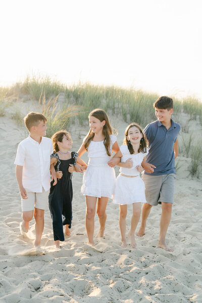 Four children hug at the beach in a Delaware State Park