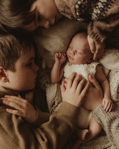 newborn baby and mum hugging