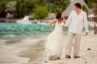 Bride and Groom walking on beach