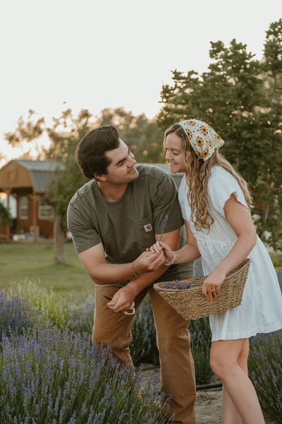 Photo taken by Bailee Freeman Photography at the Idaho Lavender Farm gardens with a boy and girl picking lavender and putting it in a basket. 