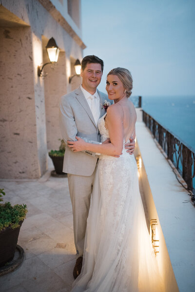 Couple stands outside at Cabo wedding. 