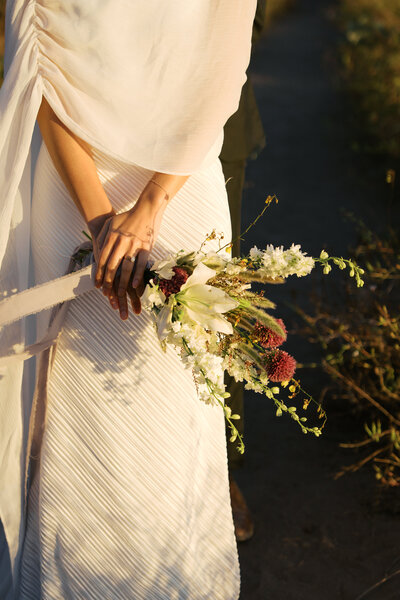 bride eating ice cream on her wedding day in the city 