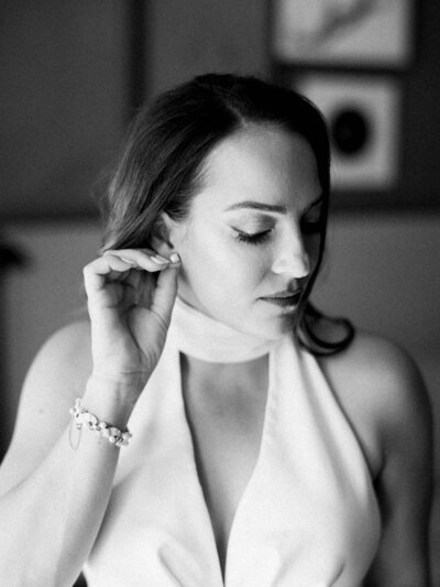 bride and groom surrounded by pink roses in a garden smiling by Colorado Wedding Photographer JKG Photography