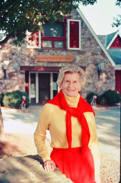 woman in red and yellow sweater at a vineyard