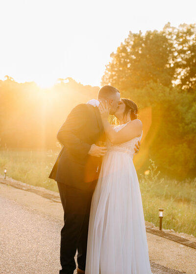 Golden hour drinks kissing couple wedding day