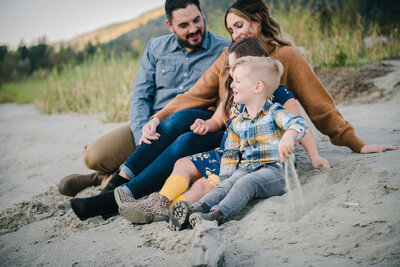 family photography gallery with family of four on a beach, photo by Jessica Stewardson