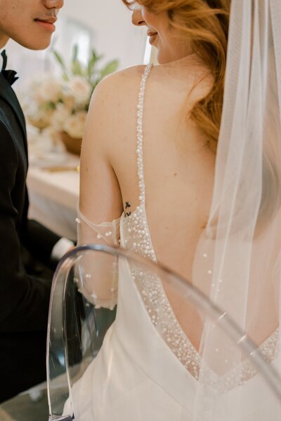 black and white photo of bridal gown hanging up