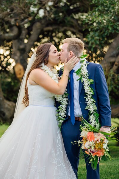 a kiss between bride and groom after their big island elopement ceremony
