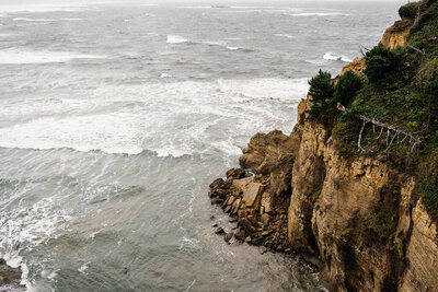 Large waves crash against a cliff on the Oregon coast