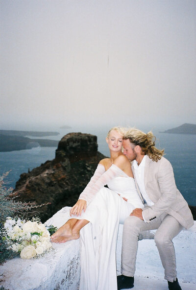 film photography of bride and groom at Skaros Rock in Santorini, Greece