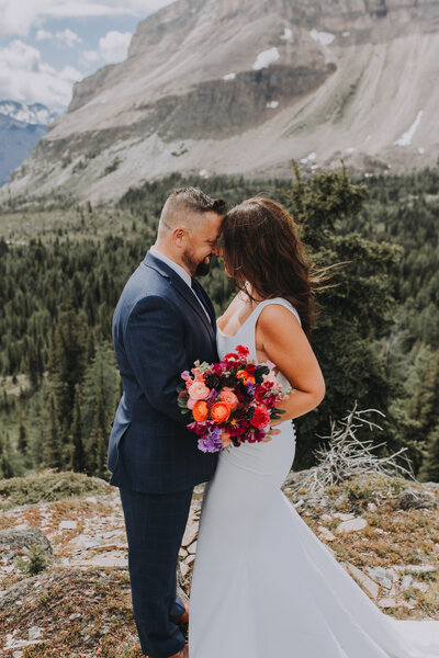 Wedding photo of couple on mountain during heli elopement